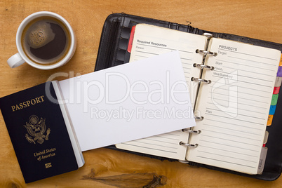 Open diary, passport and a cup of coffee