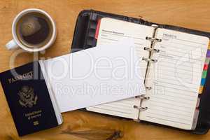 Open diary, passport and a cup of coffee