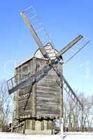 Old wooden windmill close up in winter