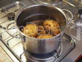 Boiling potato in saucepan