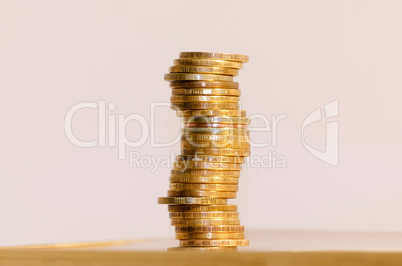 Stack of coins close-up on a gold background