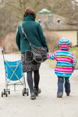 Woman with stroller running with child's hand