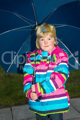 Little girl with raincoat outdoors