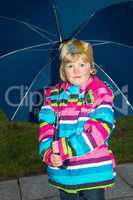 Little girl with raincoat outdoors