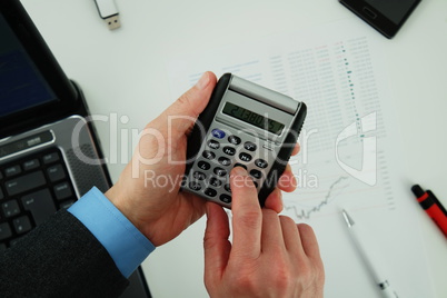 Businessman using calculator