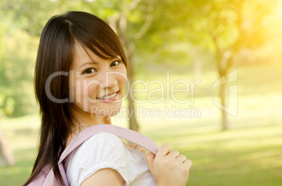 Young Asian college girl student smiling