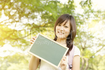 Young Asian college girl student showing blank chalkboard