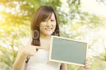 Asian college student showing blank chalkboard