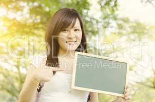 Asian college student showing blank chalkboard