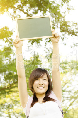 Asian college girl student with blank chalkboard