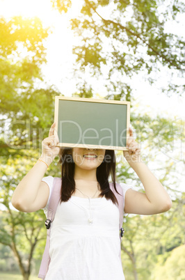Asian college student with blank chalkboard