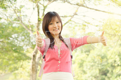 Young Asian college student showing thumb up