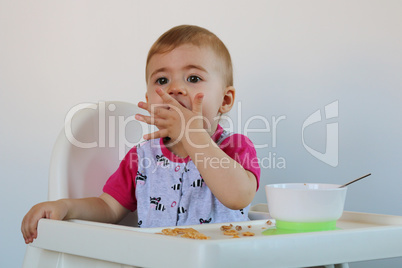 little girl sits on a chair