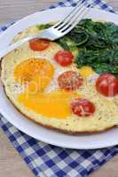 Scrambled eggs with tomato and spinach