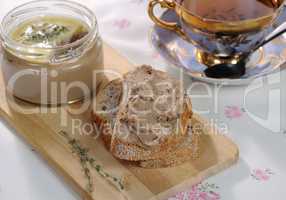 Chicken liver pate on bread and in jar