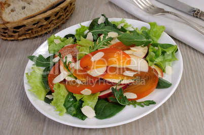 Salad greens with persimmon and almonds