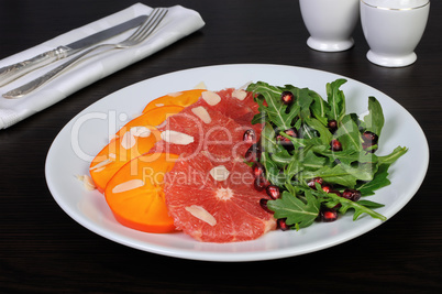 Salad of grapefruit, persimmon, pomegranate and rocket salad