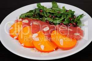 Salad of grapefruit, persimmon, pomegranate and rocket salad