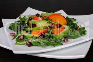 Salad with avocado, grapefruit, persimmon