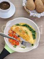Omelet with spinach, cheese and roasted tomatoes