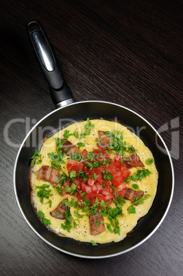 Omelet  bacon slices, tomatoes with herbs