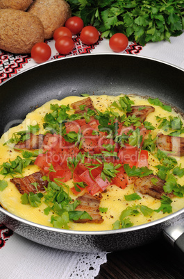 Omelet  bacon slices, tomatoes with herbs