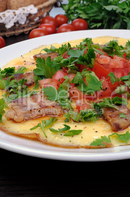 Omelet  bacon slices, tomatoes with herbs