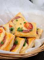 Appetizer of puff pastry with salami