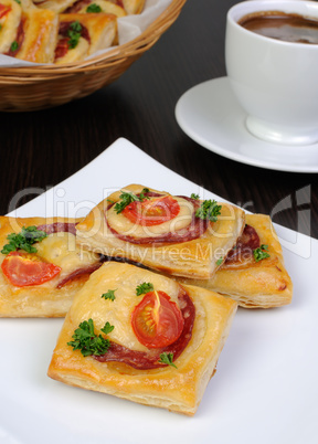 Appetizer of puff pastry with salami