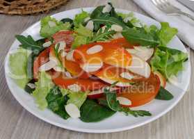 Salad greens with persimmon and almonds