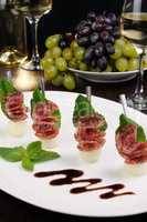 Canape of balls with a melon and salami