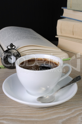 cup of coffee among the books