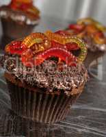 Muffin with cream in wafer crumbs and jelly worms