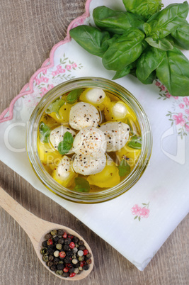 Baby mozzarella in oil with spices