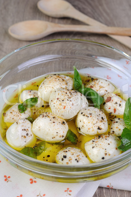 Baby mozzarella in oil with spices