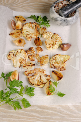 Warm appetizer of fried pieces of cauliflower with garlic and on
