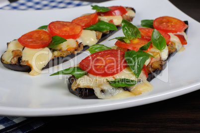 Baked eggplant with tomato and basil and cheese