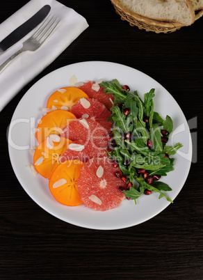 Salad of grapefruit, persimmon, pomegranate and rocket salad