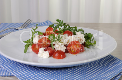 salad arugula with cherry tomatoes and mozzarella