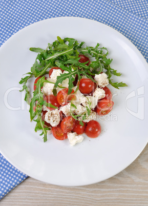 salad arugula with cherry tomatoes and mozzarella