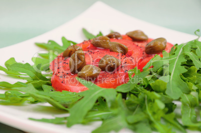 Salad with fresh tomatoes, capers and arugula