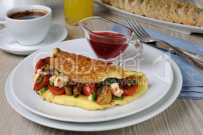 Omelette with cherry tomatoes, mushrooms and feta cheese
