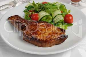 Grilled steak with vegetables on bone