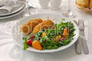 Chicken schnitzel garnish of arugula and tomatoes