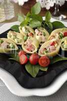 Sea shells pasta stuffed with vegetables and ham