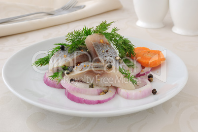 Slices of salted herring with onions and spices