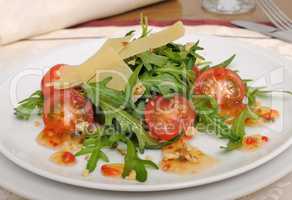 salad of arugula and cherry tomatoes with parmesan sauce