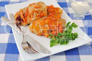 Stuffed cabbage stewed in tomato gravy with onions and carrots