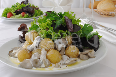 Balls potatoes with mushrooms and cream sauce in lettuce leaves