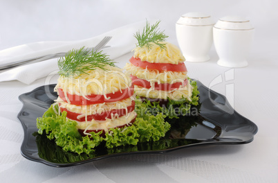 Appetizer of tomato slices with a sharp cheese filling